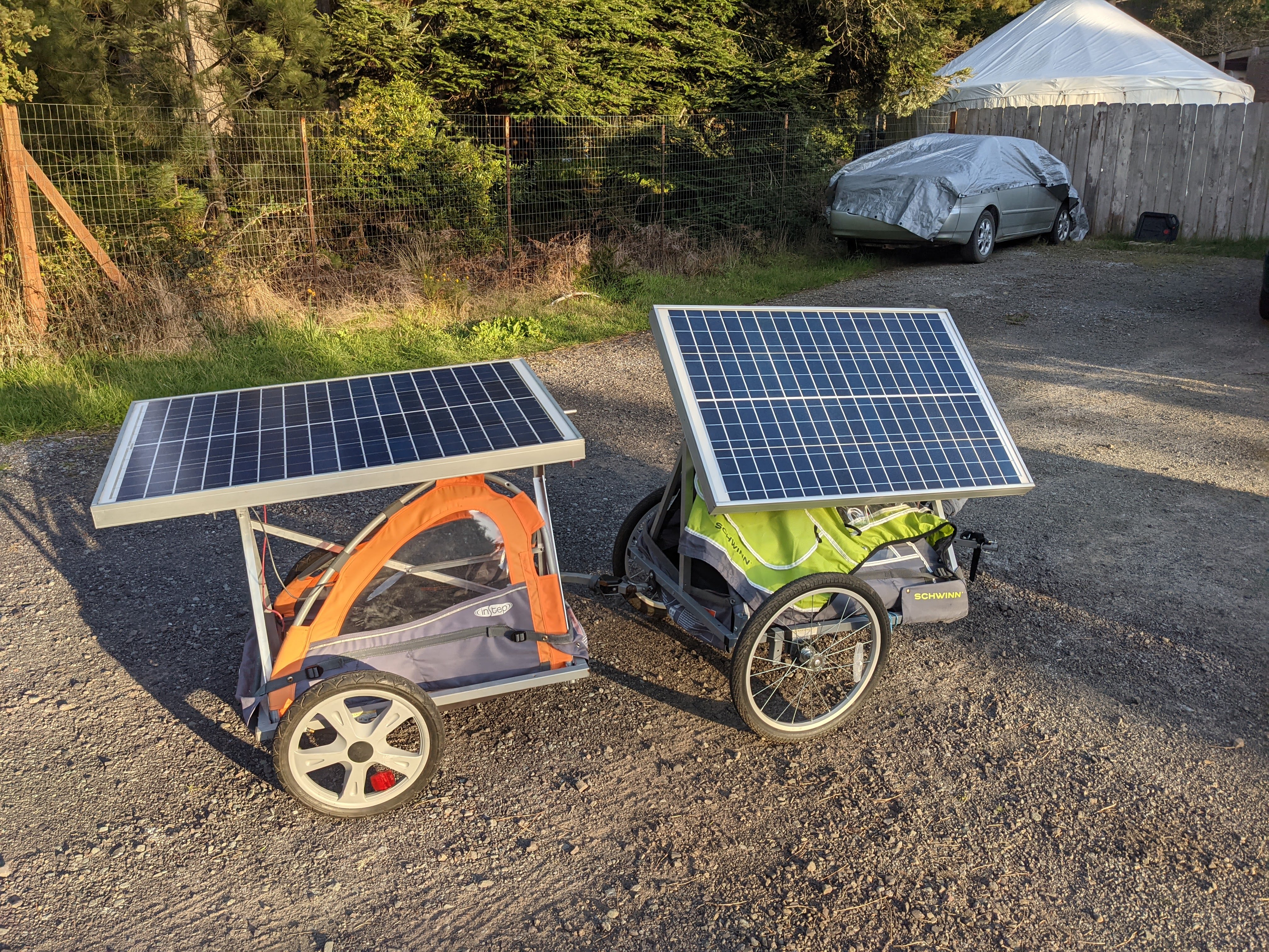 solar panel trailer connected using pivoting attachment arms