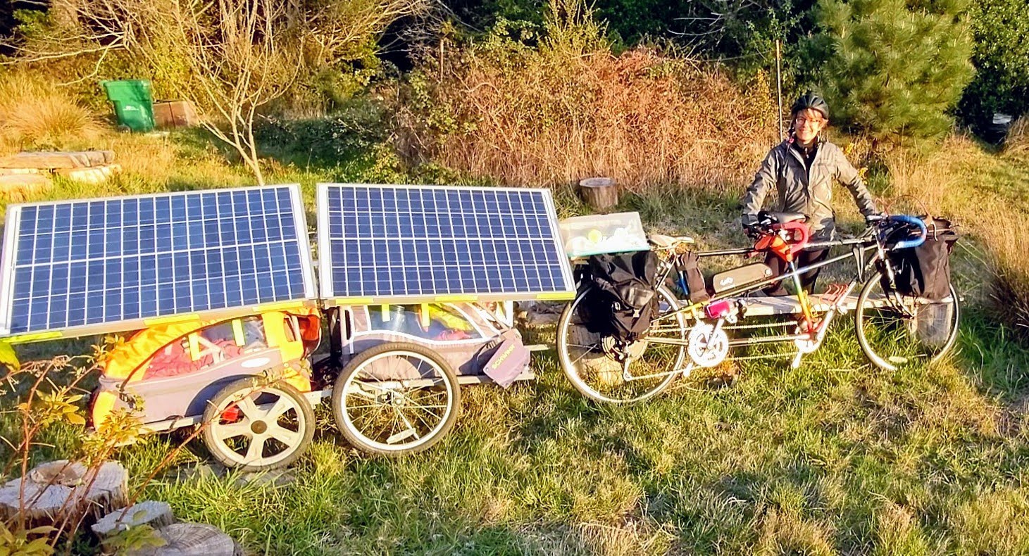Claire holding ebike and solar trailer
