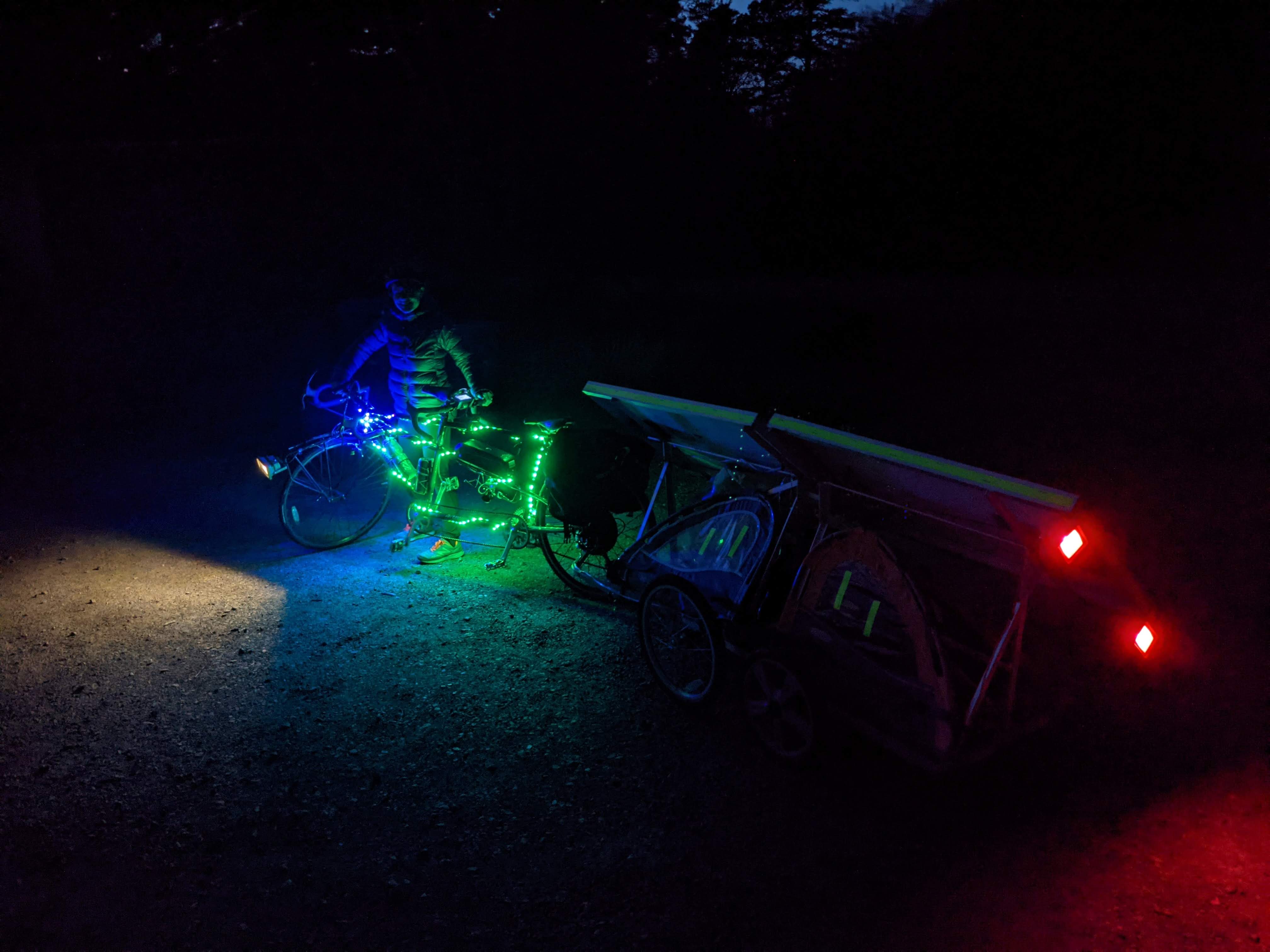 ebike trailer lit up with blue/green lights and tail light